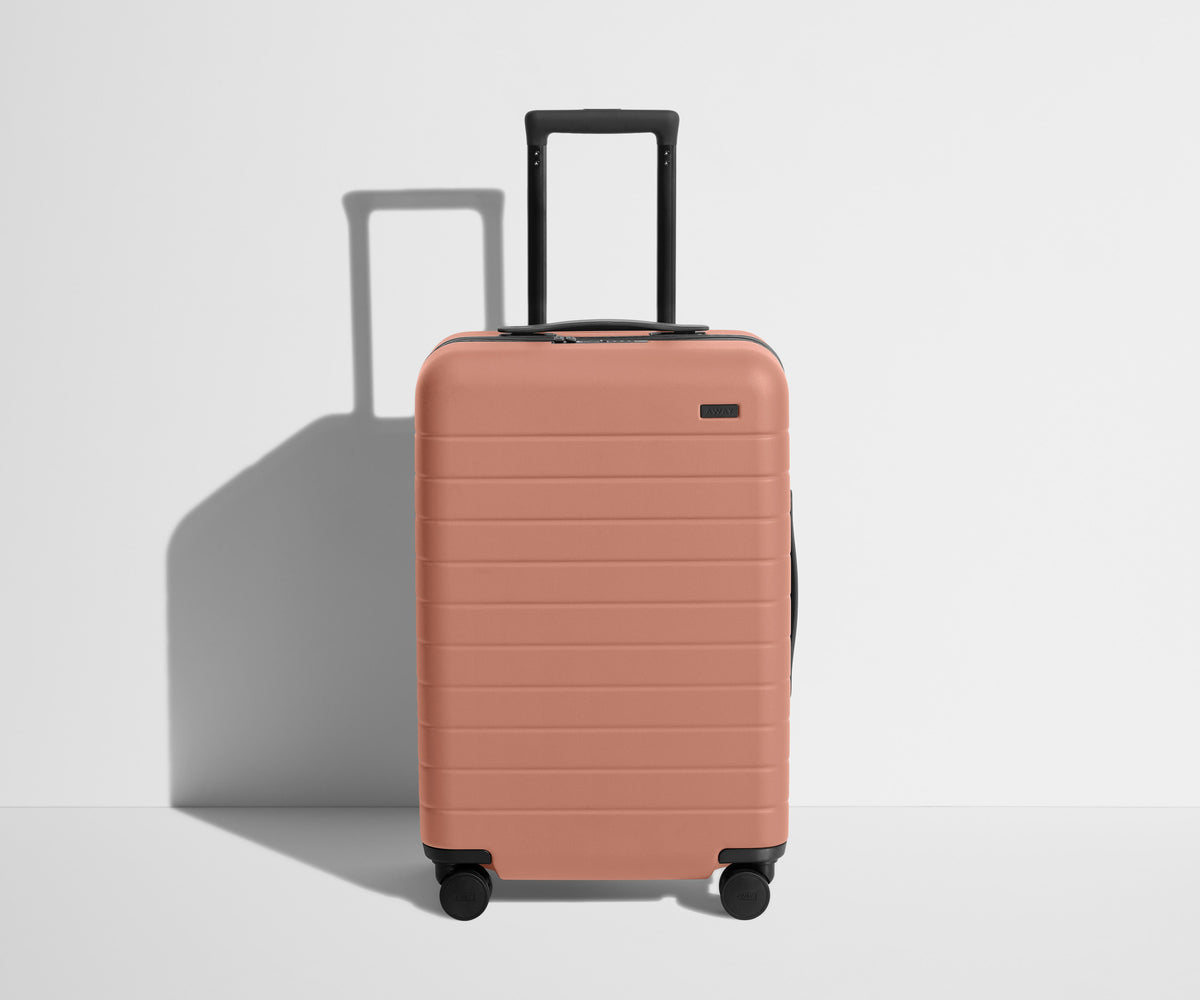 away-the-bigger-carry-on-in-clay-pink-hard-shell-carry-on-luggage image 1